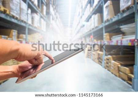 check stock tablet hand in warehouse store Royalty-Free Stock Photo #1145173166