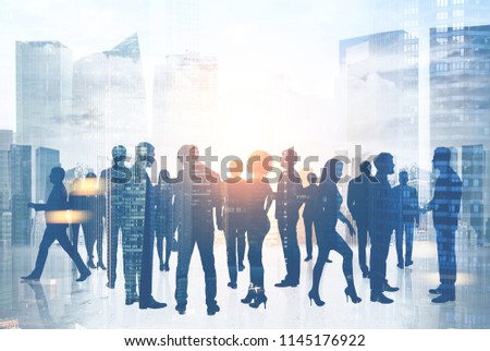 Silhouettes of business people communicating a against a modern city background. Concept of corporate life. Toned image double exposure