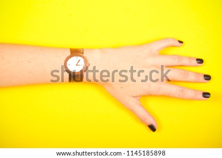 a clock painted on a woman's hand has a place for an inscription