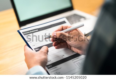 Survey, agreement or application paper. Man writing personal information to questionnaire, contract or home insurance paper. Customer or employee satisfaction poll. Royalty-Free Stock Photo #1145205020