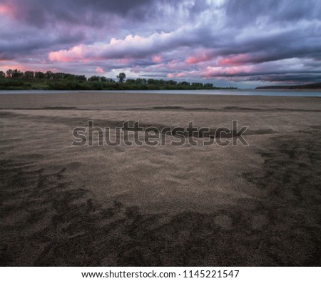 patterns on the sandy bank of the river at sunset