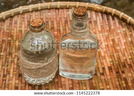 Bottles with coconut oil on vintage wooden background. 