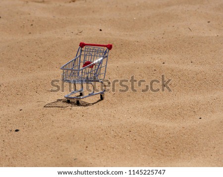 A shopping trolley in a desert.