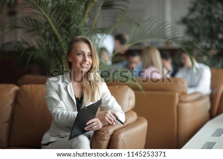 close-up of confident business woman with documents in the business center.