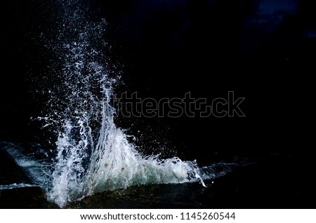 Splashing wave on the Black sea in the night. Royalty-Free Stock Photo #1145260544