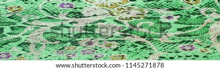 The skin texture, green color patterned. skin texture in light green color.  Close up photo of green color filtered leather surface texture style represent the surface background.