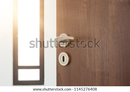 Half opened door to a ampty room. Door handle, door lock. Welcome, to new home concept