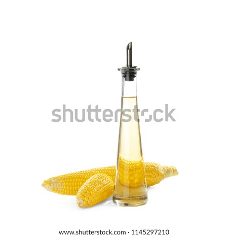 Bottle of corn oil and fresh cobs on white background