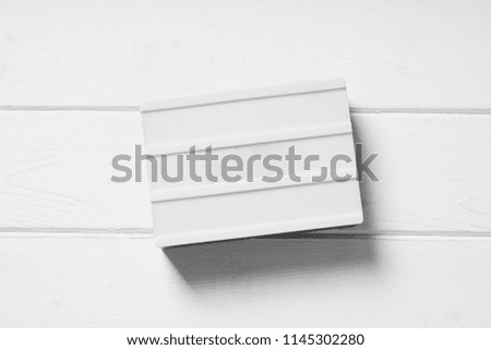 blank light box sign on white wooden background