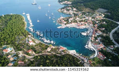 Aerial drone photo of picturesque and iconic port of Fiskardo with luxury boats docked and traditional character at sunset, Cefalonia island, Ionian, Greece