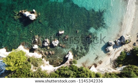 Aerial drone photo of volcanic beach of Kalamia with white rock formations and turquoise beach with sun beds, Argostoli, Cefalonia, Greece