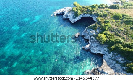 Aerial drone photo of tropical volcanic cave beach with turquoise clear sea