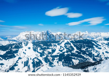 Beautiful ski resort right in the middle of the mountains in Austrian Alps. Amazing winter mountain view with small wooden houses and mountain slopes.