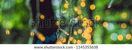 LED lights garland, colorful light bulbs on a bokeh background BANNER, long format