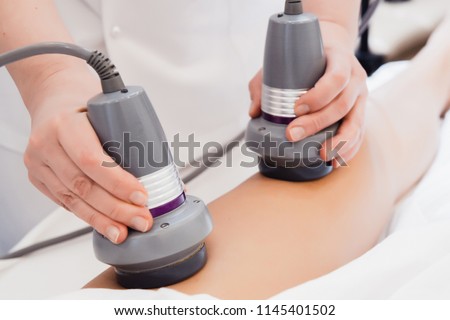 Body care. Ultrasound cavitation body contouring treatment. Radiofrequency therapy. Active thermolysis. lifting. Body massage with bipolar radio frequencies  Royalty-Free Stock Photo #1145401502