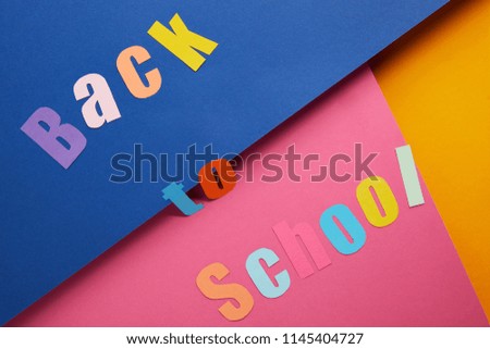 flat lay with "back to school" lettering on colorful paper background