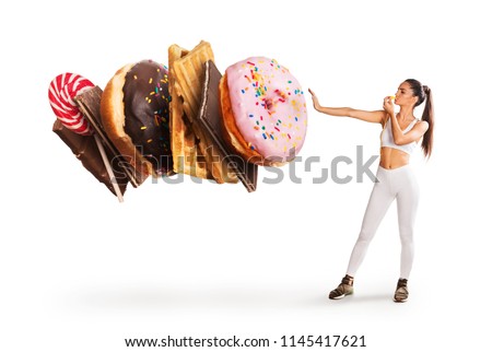 Fit young woman saying NO to sweets Royalty-Free Stock Photo #1145417621