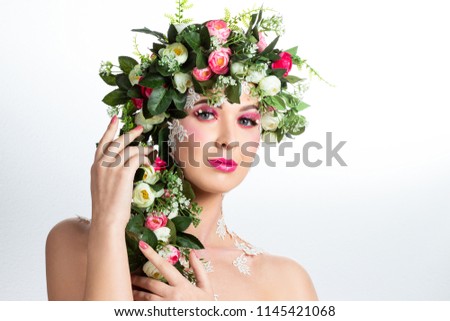 Portrait of a beautiful brunette with huge erect eyelashes in the image of spring with a wreath of roses on his head on a white background.