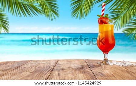 Summer drink on desk and beach landscape 