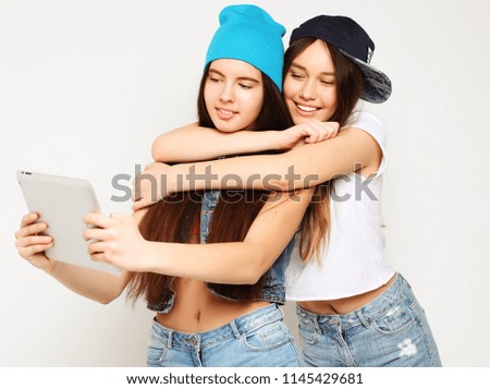 lifestyle, tehnology and people concept: Happy girls  with tablet computer over white  background. Happy selfie.