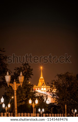 Night scene of Phu Khao Thong (Golden Mountain) in Wat Saket temple compound,Pom Prap Sattru Phai district,Bangkok,Thailand. Royalty-Free Stock Photo #1145469476