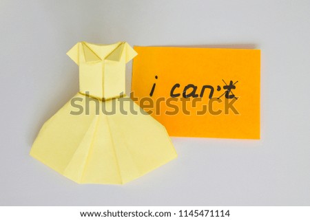 I can, no crossed out, inscription on note. Believe in yourself. Motivation to achieve results. Management in business, leadership positions. Dress made of paper, origami. Sticker with text.