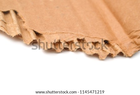 Brown corrugated texture paper torn on white background. rip of cardboard sheet used as a background.