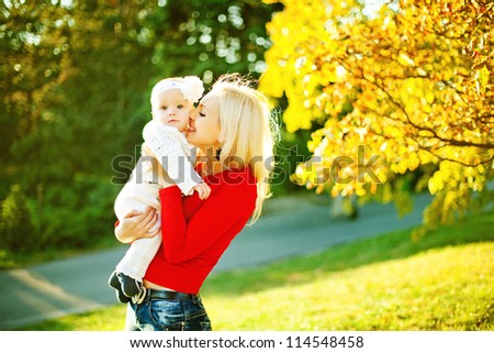 Happy mother with child in autumn day