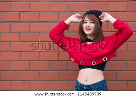 Portrait of beautiful asian chic girl wear black dress pose for take a picture on brick wall,Lifestyle of teen thailand people,