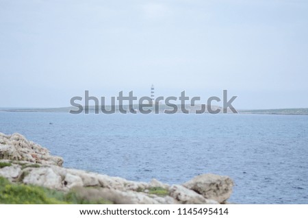 Landscape photography of the coast of Menorca with the island of the air in the background.
