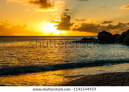 Travel photo in St. Barths, Caribbean. Amazing view of sunset on Shell Beach in Gustavia, Caribbean. Royalty-Free Stock Photo #1145544959