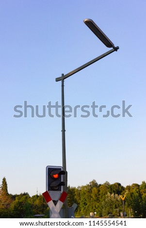 railroad crossing with red light in allgau south germany summer evening