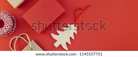 New Year or Christmas presents wrapped with ribbon flat lay top view Xmas 2019 holiday celebration handmade gift boxes on red paper background copyspace. Template mockup long wide banner design