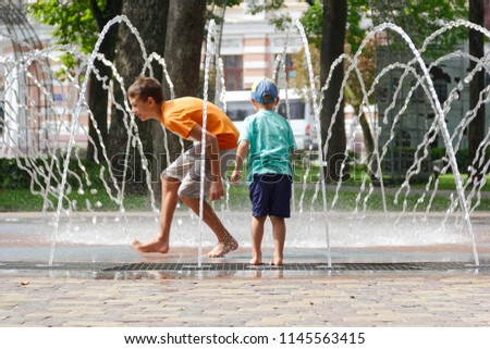 GOMEL, BELARUS Children bathing in the fountain. 