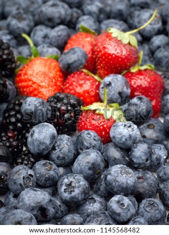Closeup of strawberries, blackberries and blueberries. Studio image high resolution photo.