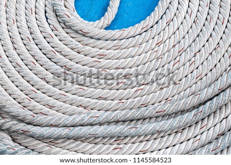 rope thick twisted white stacked circle round rings tightly on a blue background contrasting design