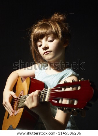 Girl play guitar red hair
