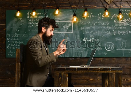 Mature tutor teacher giving private lessons to preschool boy, Teacher drawing at classroom in school, Concept education - back to school on green background