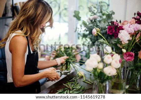Florist makes a bouquet. Royalty-Free Stock Photo #1145619278