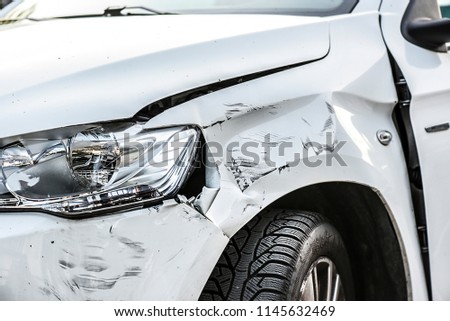 Car crash or accident. Front fender and light damage and scratchs on bumper. Broken vehicle detail or close up.  Royalty-Free Stock Photo #1145632469