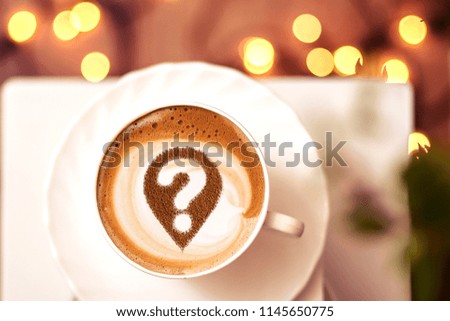 Coffee cup with question mark in the froth concept for problems, uncertainty and asking questions
