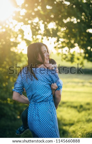 mom and son have a rest and play in the nature