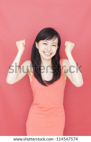 happy young woman against red background