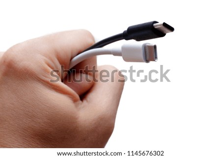 Hand holding black and white Usb type-c connector isolated on white background