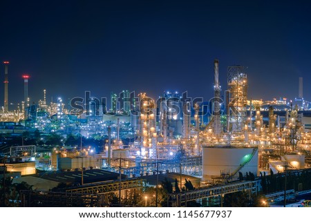 Oil and Gas refinery industry plant with glitter lighting, Factory of petroleum industrial at night time, Petrochemical plant with gas distillation tower and storage tank Royalty-Free Stock Photo #1145677937