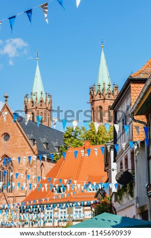 Oktoberfest decoration in the streets of old German town Ladenburg. Old frame houses in german medieval city. Street with traditional Houses and Oktoberfest garland