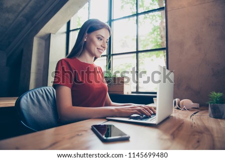 Young, business woman sitting in workstation, using portable computer device. Work in progress concept