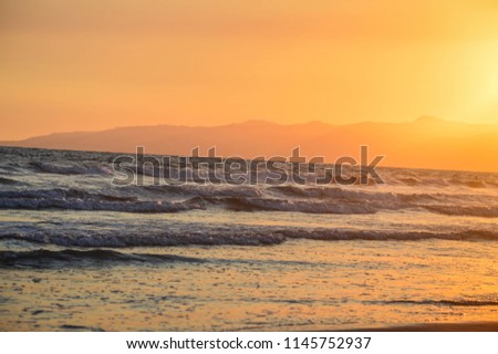 Calm waves at Venice Beach at sunset