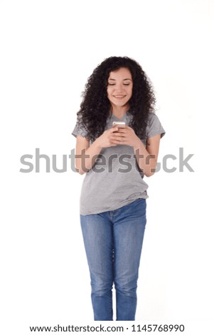 Young beautiful woman using her smartphone. Indoor. Isolated white background.
