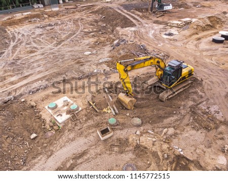 yellow excavator machine working in construction site. aerial view